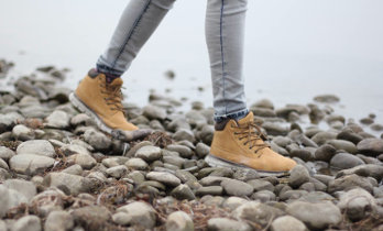 Walking over pebbles by the seashore